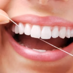 Patient flossing between professional dental cleanings at a Denver dental office