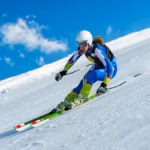 Skier racing downhill on a Colorado slope during ski season near Denver
