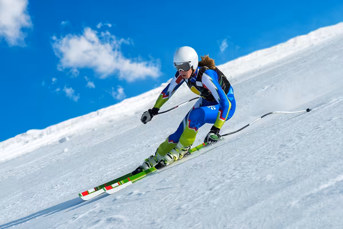 Skier racing downhill on a Colorado slope during ski season near Denver